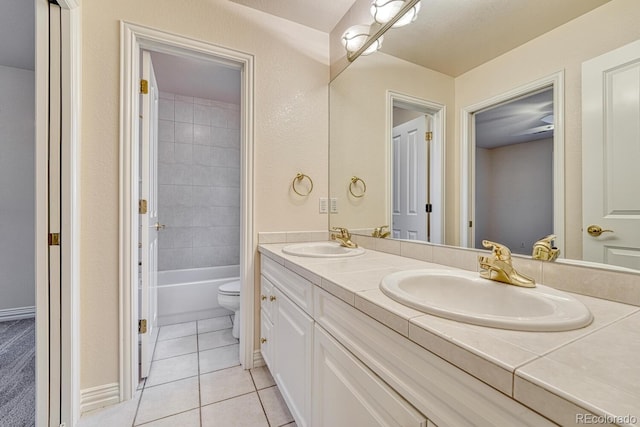 bathroom with vanity, toilet, and tile patterned flooring