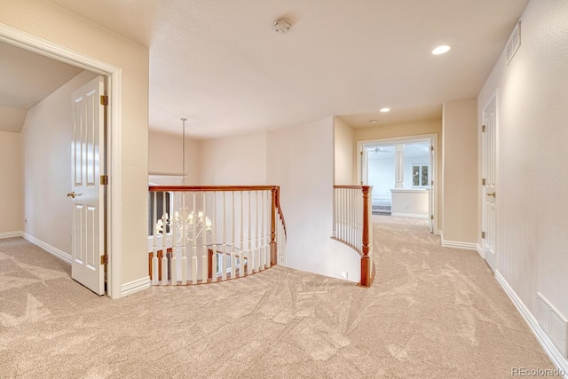 corridor featuring light colored carpet