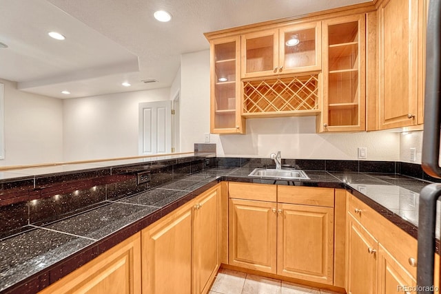 kitchen featuring light tile patterned flooring and sink