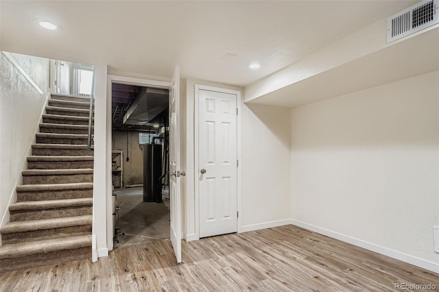 15775 E 13th Pl, Aurora, CO 80011 - finished below grade area featuring stairway, water heater, light wood-style flooring, and recessed lighting