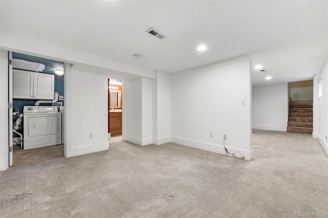 unfurnished living room featuring independent washer and dryer and light colored carpet