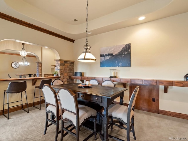 17121 Snow Creek Ln, Morrison, CO 80465 - dining area featuring light colored carpet, arched walkways, recessed lighting, and ornate columns