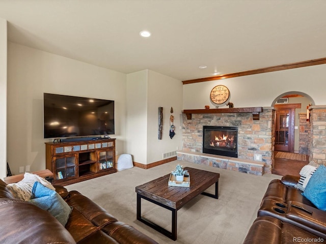17121 Snow Creek Ln, Morrison, CO 80465 - living area featuring a stone fireplace, carpet flooring, arched walkways, ornamental molding, and recessed lighting