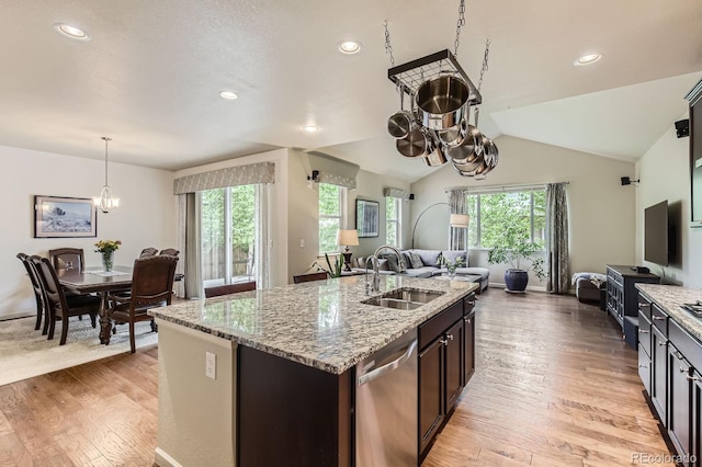 853 Jenny Ln, Berthoud, CO 80513 - kitchen with a sink, open floor plan, dishwasher, light wood-style floors, and light stone counters