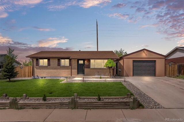 7961 Granada Rd, Denver, CO 80221 - ranch-style house with brick siding, concrete driveway, and a detached garage