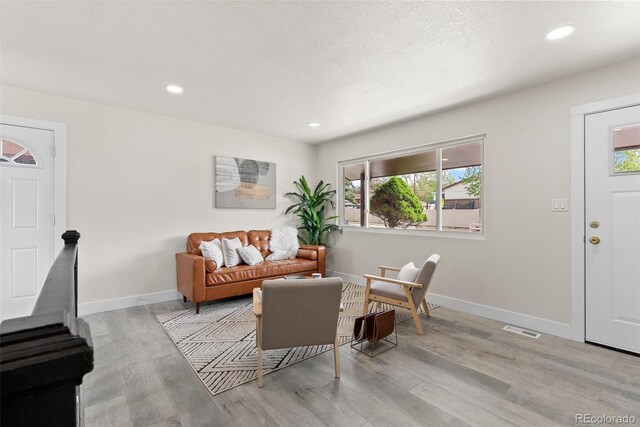 7961 Granada Rd, Denver, CO 80221 - living room featuring wood finished floors, baseboards, and recessed lighting