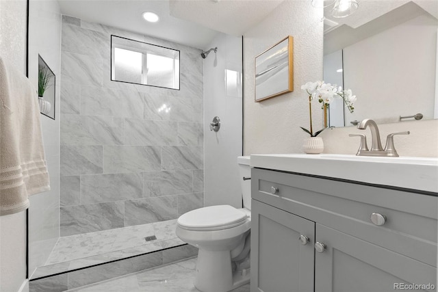 7961 Granada Rd, Denver, CO 80221 - bathroom with marble finish flooring, toilet, vanity, and a tile shower