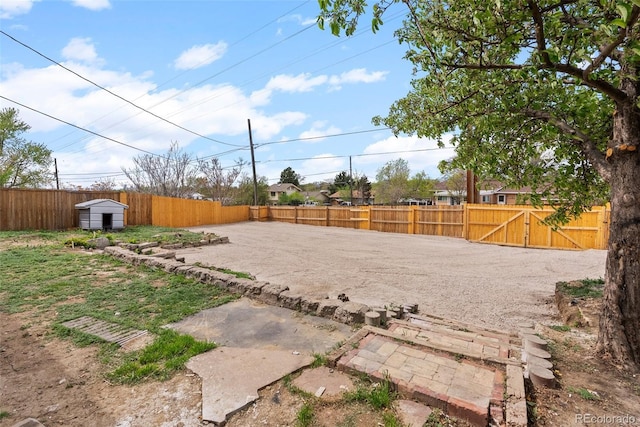 7961 Granada Rd, Denver, CO 80221 - fenced backyard featuring a storage unit, a gate, and an outdoor structure