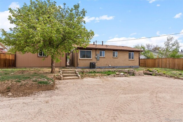 7961 Granada Rd, Denver, CO 80221 - ranch-style home with central air condition unit, brick siding, and fence