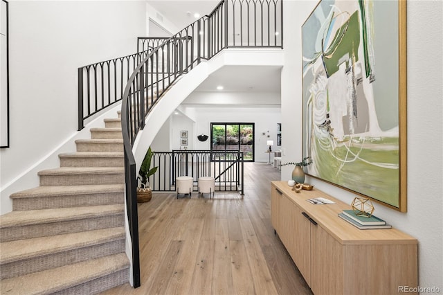 5569 Willow Springs Dr, Morrison, CO 80465 - entryway featuring light wood-type flooring, stairs, a towering ceiling, and recessed lighting