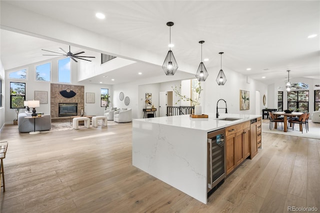 5569 Willow Springs Dr, Morrison, CO 80465 - kitchen with wine cooler, open floor plan, a ceiling fan, vaulted ceiling, and light wood-type flooring