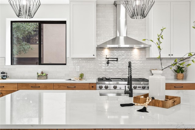 5569 Willow Springs Dr, Morrison, CO 80465 - kitchen with wall chimney exhaust hood, a chandelier, tasteful backsplash, and white cabinets