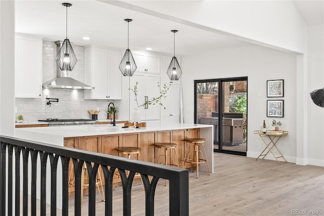 5569 Willow Springs Dr, Morrison, CO 80465 - kitchen featuring decorative backsplash, light countertops, light wood-style floors, white cabinetry, and recessed lighting