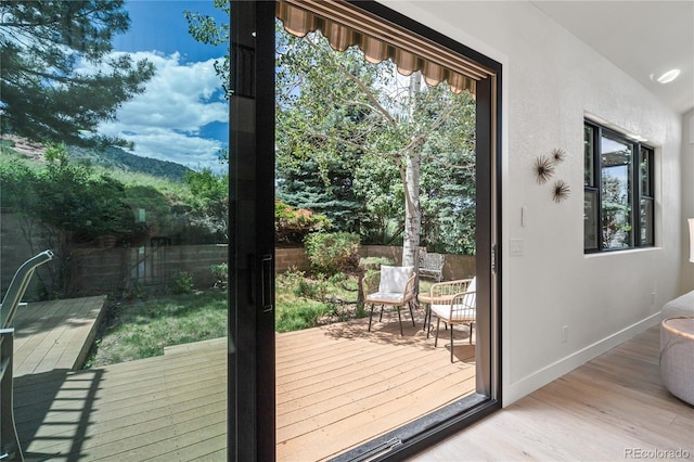 5569 Willow Springs Dr, Morrison, CO 80465 - doorway featuring wood finished floors, plenty of natural light, and vaulted ceiling