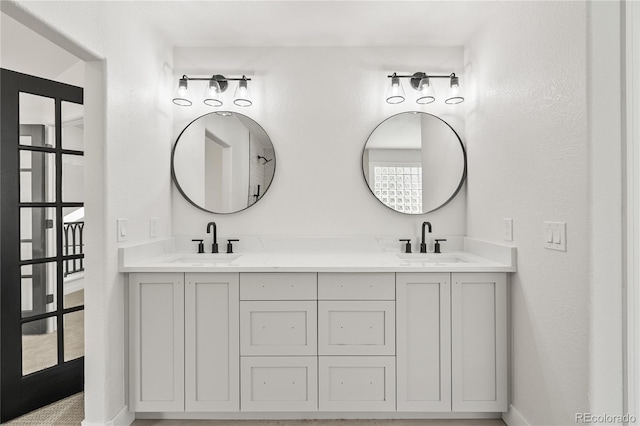 5569 Willow Springs Dr, Morrison, CO 80465 - bathroom featuring double vanity and baseboards