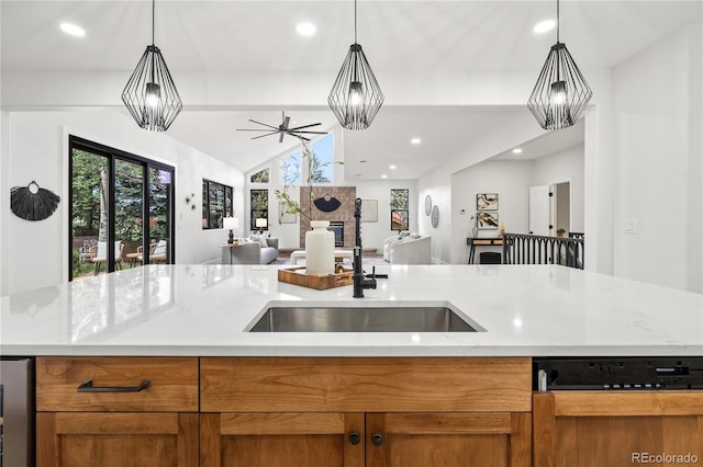 5569 Willow Springs Dr, Morrison, CO 80465 - kitchen with dishwasher, open floor plan, lofted ceiling, brown cabinets, and hanging light fixtures