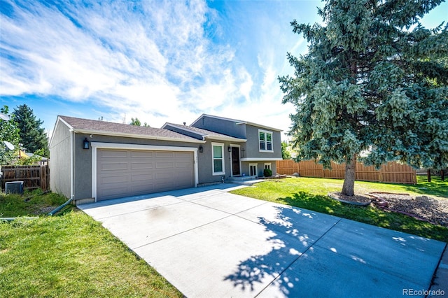 tri-level home with central AC, a front yard, and a garage