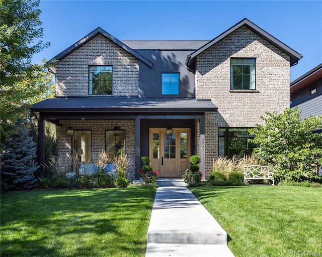 view of front of house featuring a front lawn and covered porch