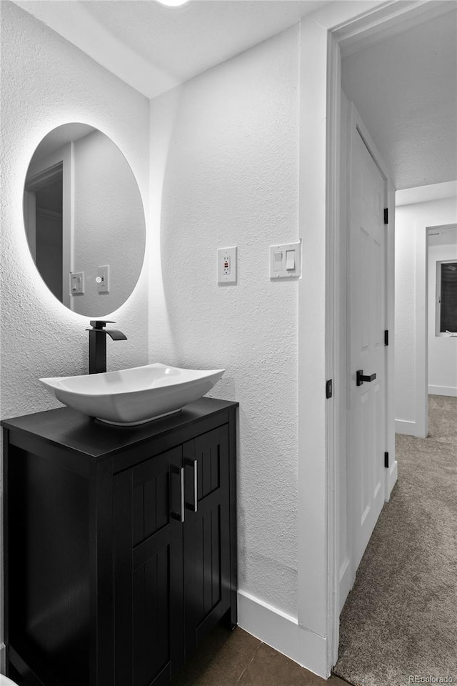 bathroom featuring vanity and baseboards