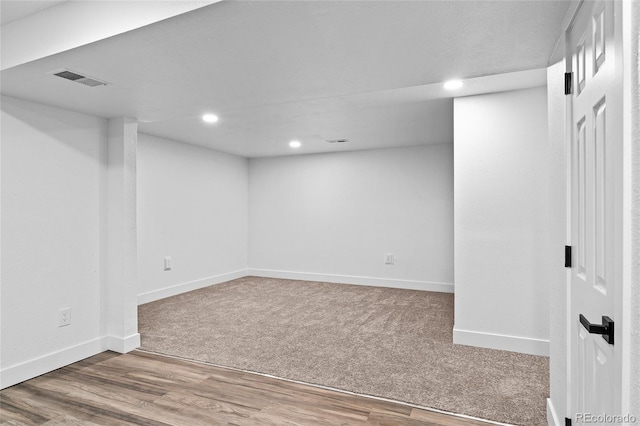 finished below grade area with recessed lighting, baseboards, carpet, and wood finished floors