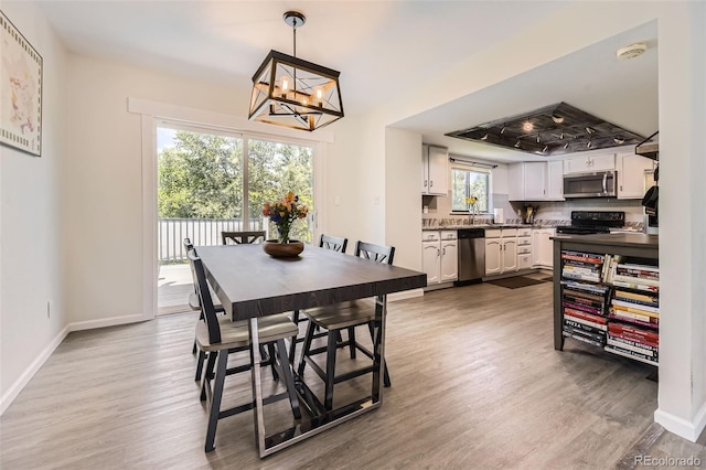 3235 S Newland St, Denver, CO 80227 - dining area with wood finished floors and a chandelier