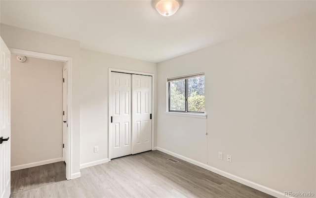 3235 S Newland St, Denver, CO 80227 - unfurnished bedroom featuring wood finished floors and a closet