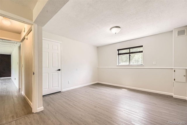 3235 S Newland St, Denver, CO 80227 - empty room with wood finished floors and a textured ceiling
