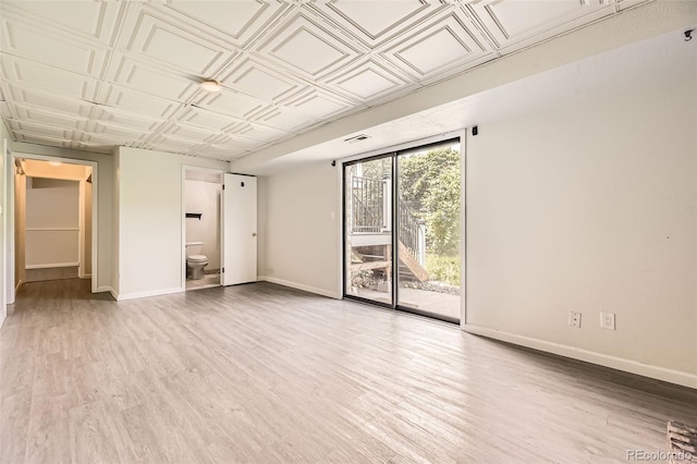 3235 S Newland St, Denver, CO 80227 - empty room featuring a wall of windows, light wood-style flooring, and an ornate ceiling