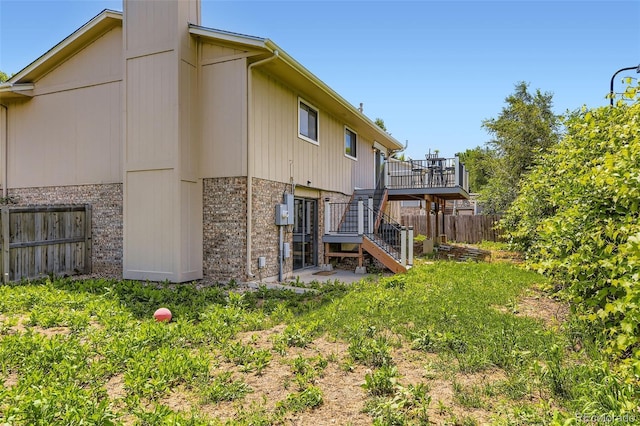 3235 S Newland St, Denver, CO 80227 - rear view of property with stairway, brick siding, and a deck