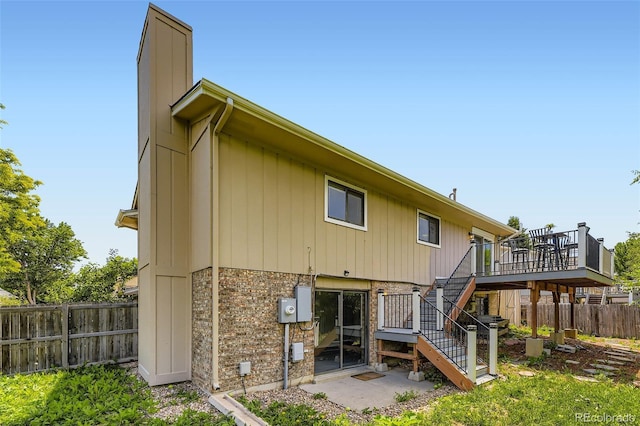 3235 S Newland St, Denver, CO 80227 - rear view of house with stairs, a deck, and a chimney