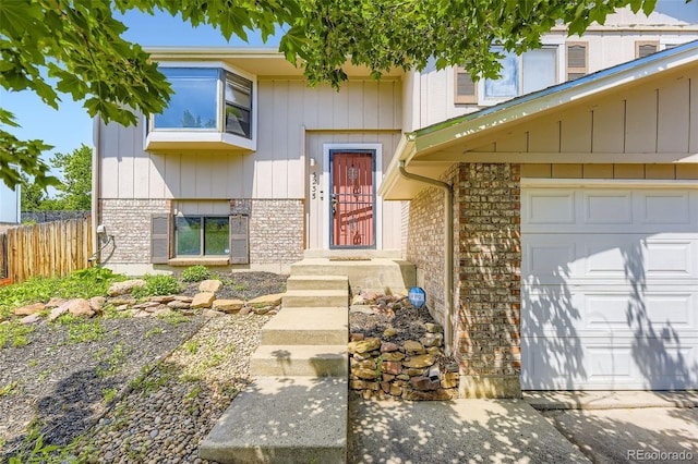 3235 S Newland St, Denver, CO 80227 - property entrance with a garage and brick siding