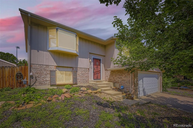 3235 S Newland St, Denver, CO 80227 - view of front of property with concrete driveway and an attached garage