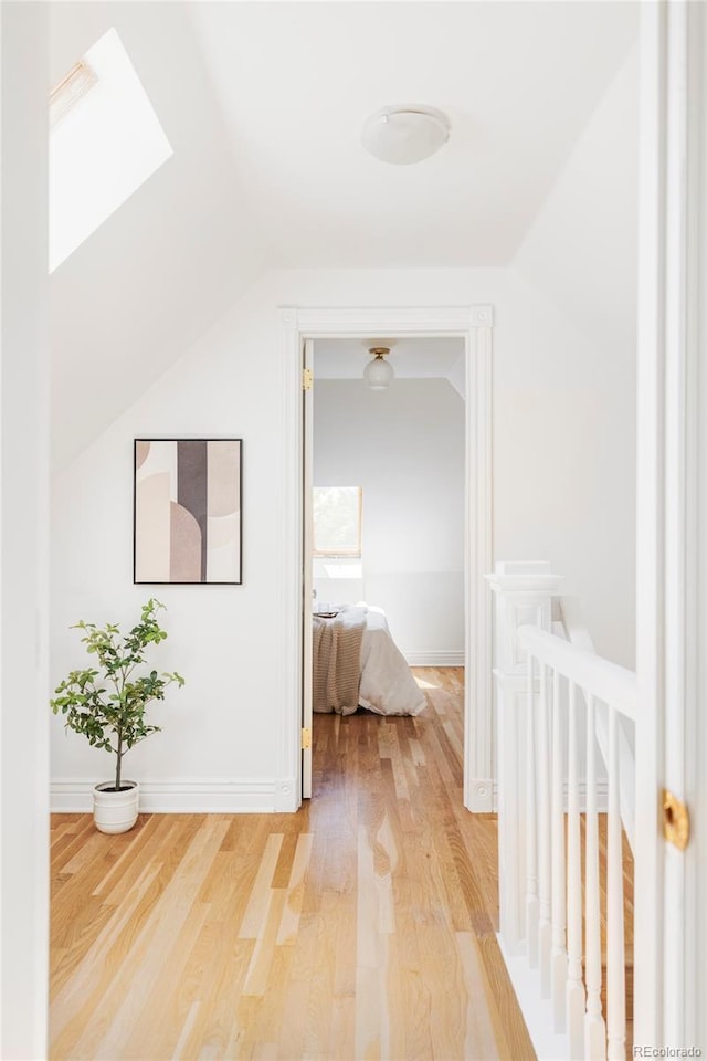 3346 W 30th Ave, Denver, CO 80211 - hallway with a skylight, light wood finished floors, and vaulted ceiling