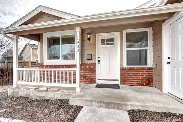 view of exterior entry with covered porch