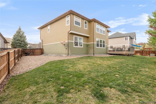 13664 Cherry St, Thornton, CO 80602 - back of property featuring a fenced backyard, a wooden deck, and a yard