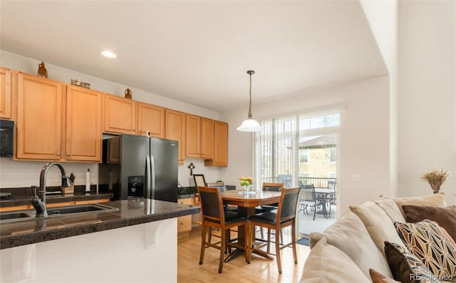 13664 Cherry St, Thornton, CO 80602 - kitchen featuring light brown cabinetry, tile countertops, a sink, stainless steel fridge with ice dispenser, and open floor plan