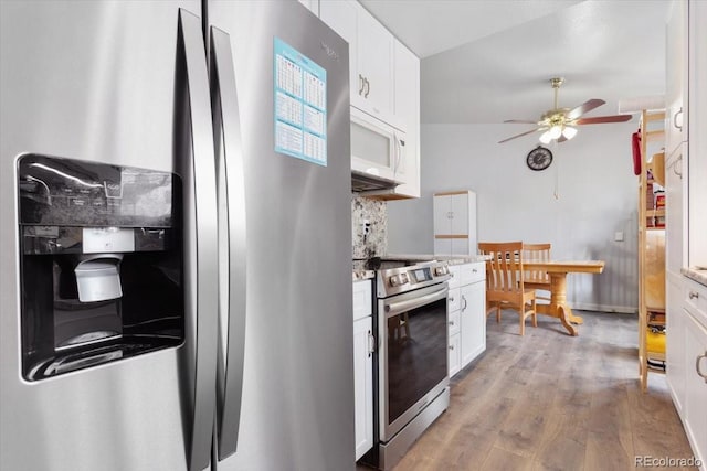 kitchen with appliances with stainless steel finishes, ceiling fan, light wood-type flooring, and white cabinets