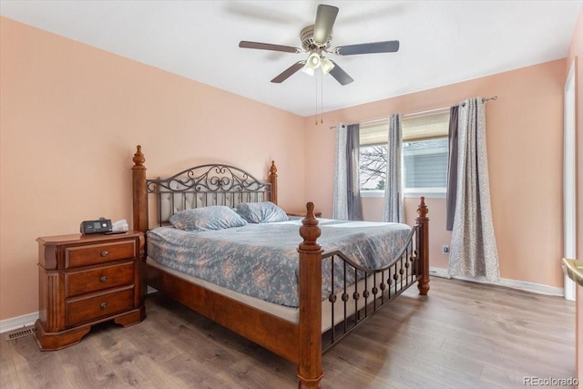 bedroom with hardwood / wood-style flooring and ceiling fan