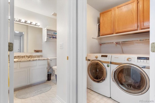 clothes washing area with sink and washing machine and clothes dryer