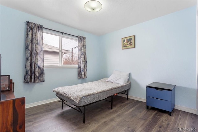 bedroom with dark hardwood / wood-style floors