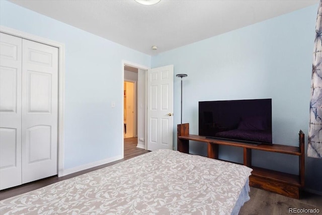 bedroom featuring a closet and dark hardwood / wood-style flooring