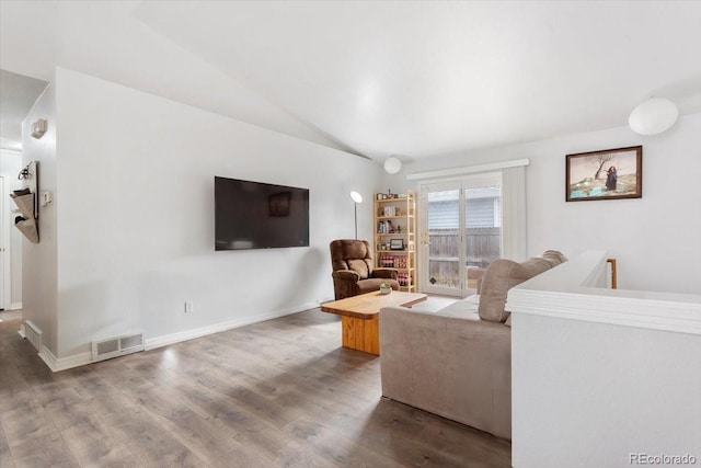 living room with hardwood / wood-style floors and lofted ceiling