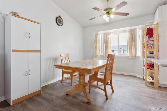 dining area featuring hardwood / wood-style flooring, ceiling fan, and lofted ceiling