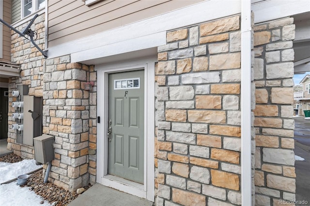 view of exterior entry featuring stone siding