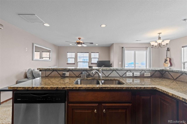 kitchen featuring visible vents, a sink, stainless steel dishwasher, and dark brown cabinets