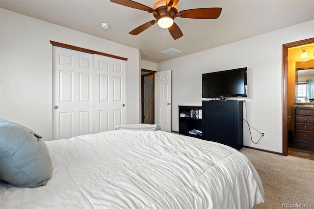 bedroom with visible vents, baseboards, a ceiling fan, light colored carpet, and a closet