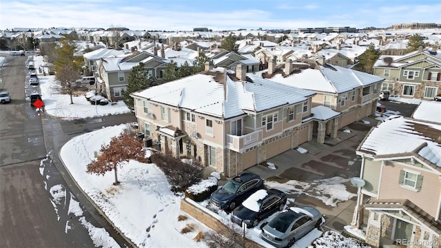 snowy aerial view featuring a residential view