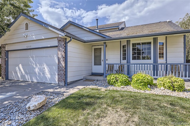 ranch-style home with covered porch, a garage, and a front lawn