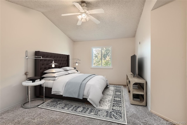 bedroom with carpet, vaulted ceiling, a textured ceiling, and ceiling fan