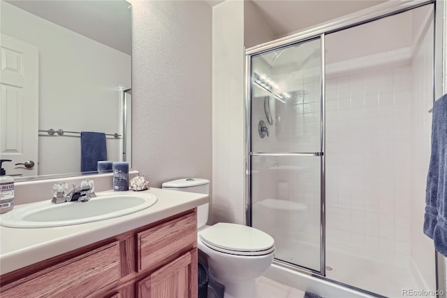 bathroom with vanity, toilet, and walk in shower